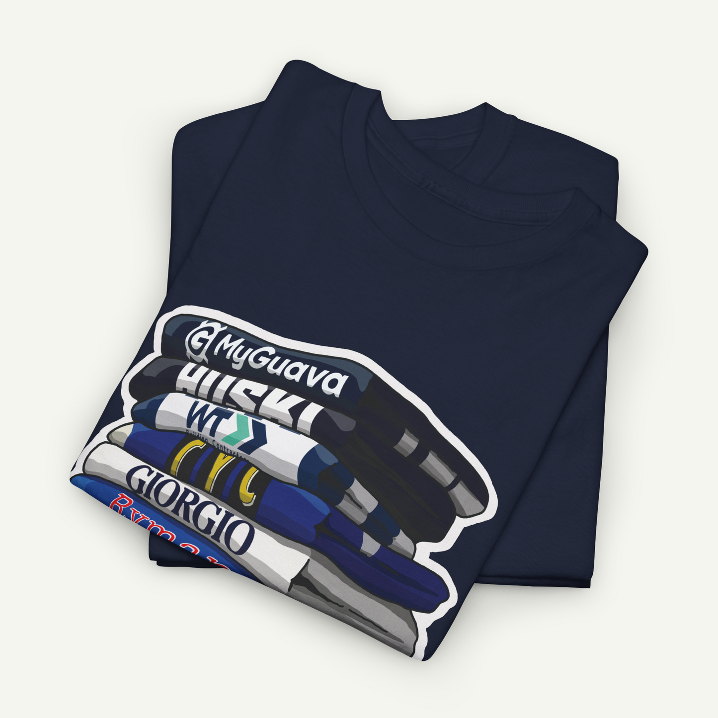 A navy blue t-shirt with a graphic design depicting a stack of books or magazines with the titles "My Guava", "Huskies", "W.T.C.G.I.R.O", and "Giorgio".