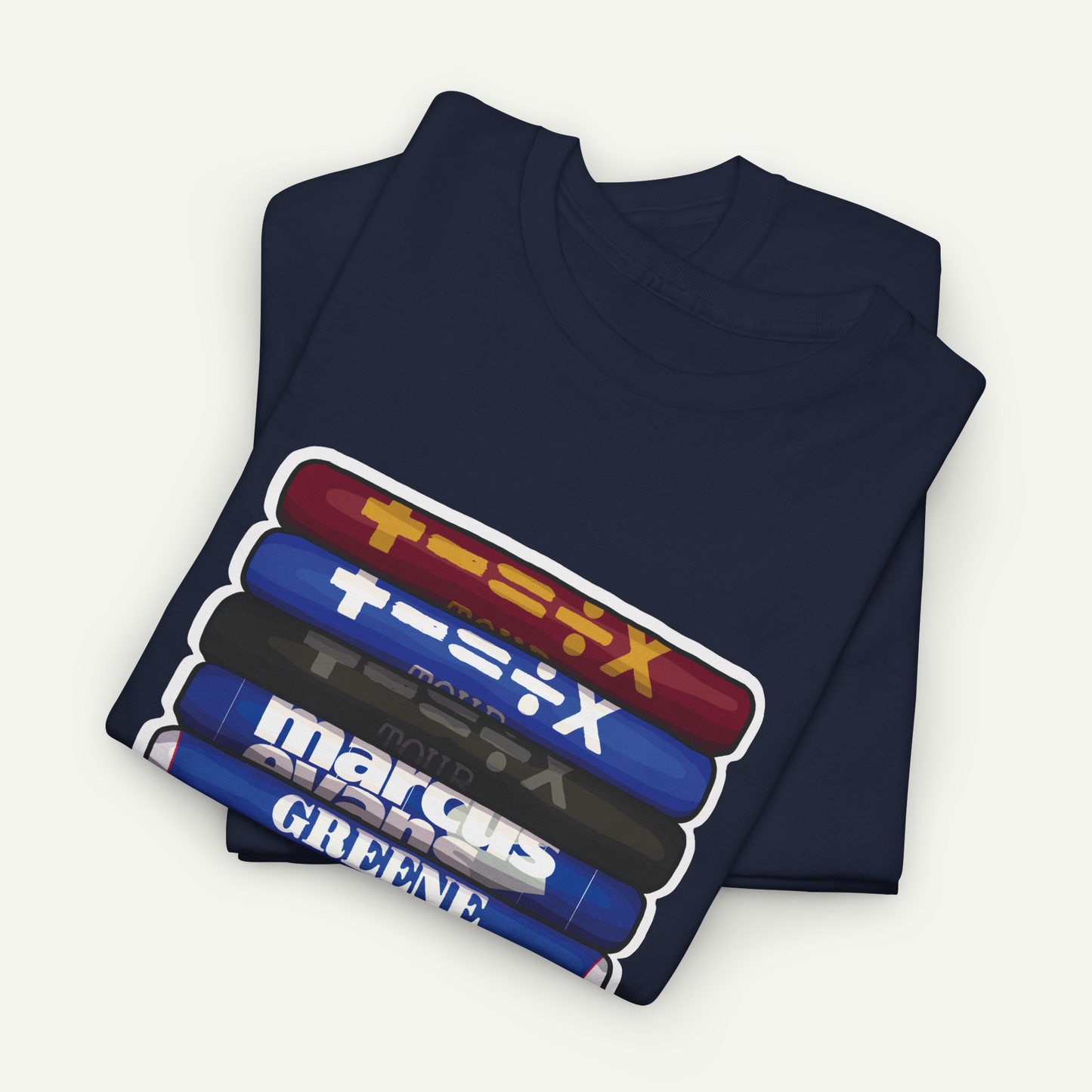 A navy blue t-shirt with a graphic design featuring a stack of colorful tubes or bottles with Japanese text on them.