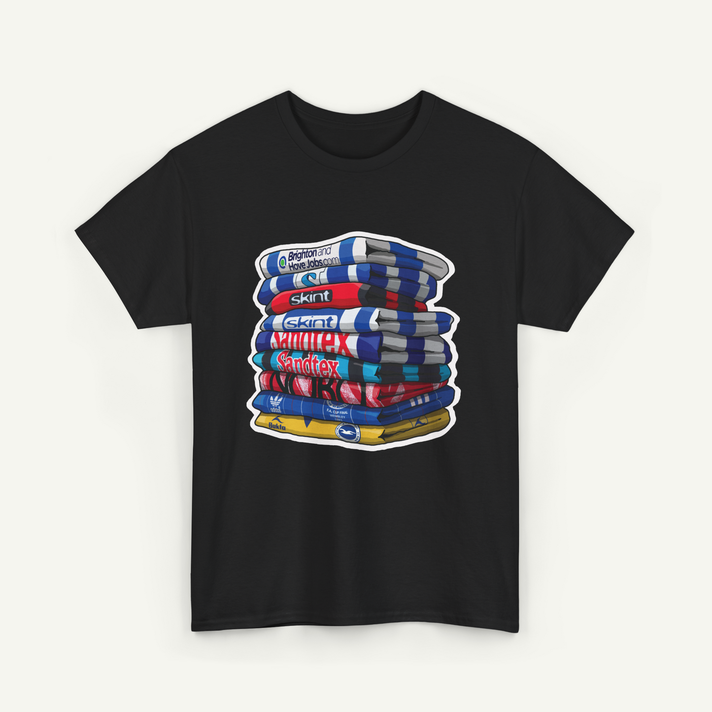 A black t-shirt with a graphic design depicting a stack of colorful books or magazines.