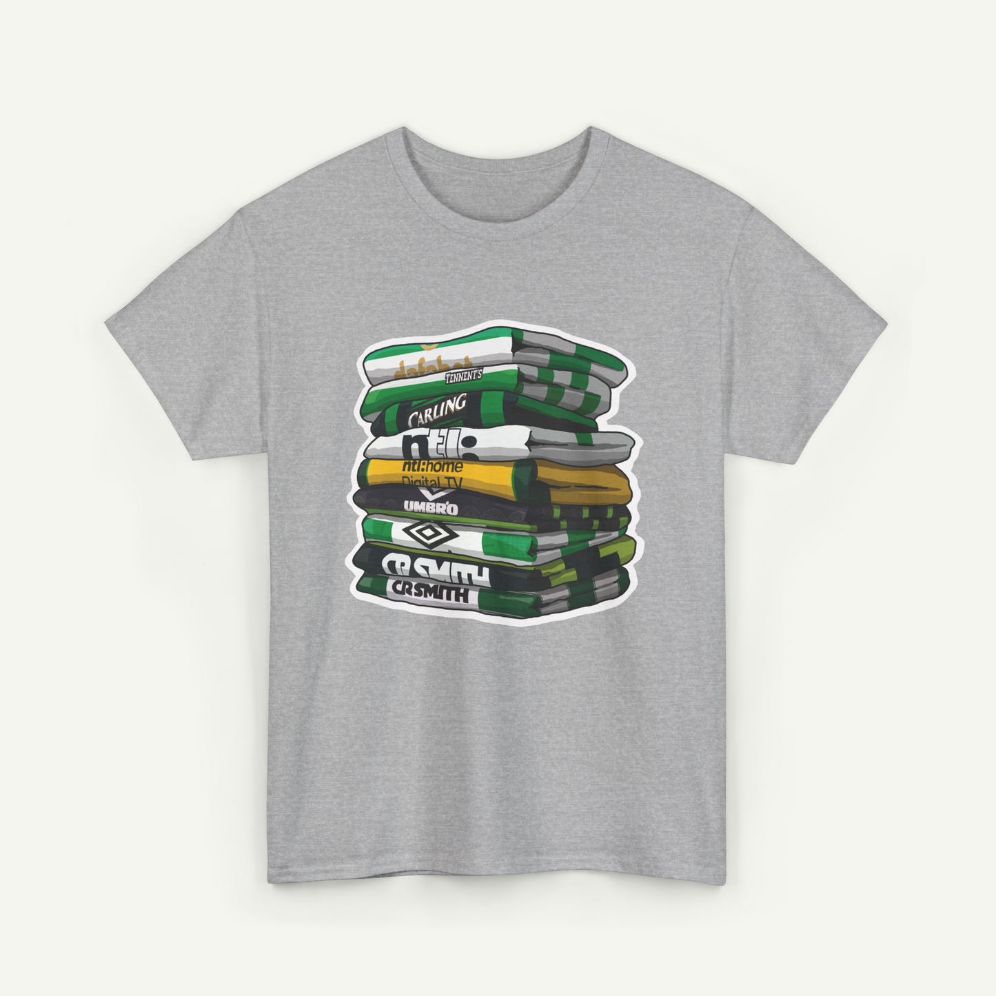 A gray t-shirt with a graphic design depicting a stack of books or magazines with various text and logos on the covers.