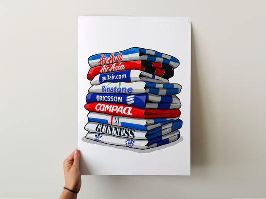 A hand is holding a poster with a stack of colorful towels, each displaying a different brand logo.