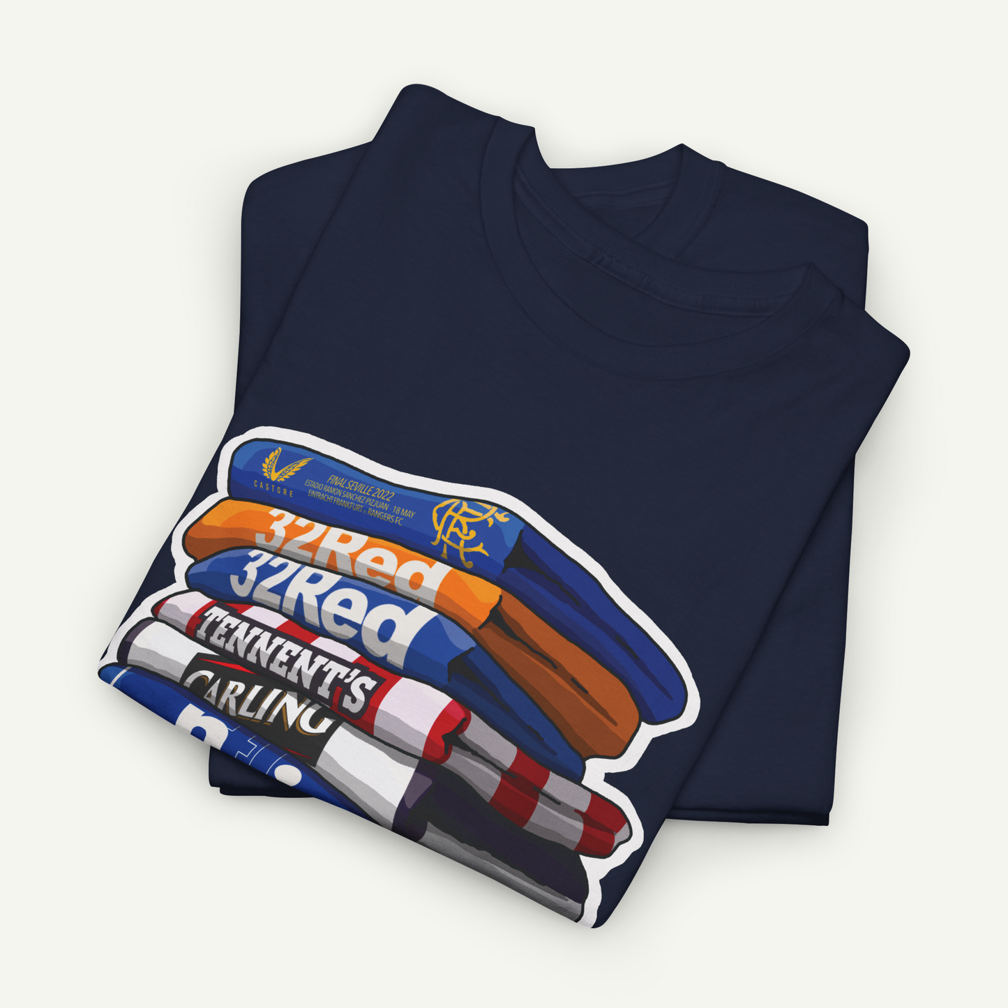 A dark blue t-shirt with a graphic design depicting a stack of books or magazines with the text "32Red" and "TENNENT'S CARLING" printed on it.
