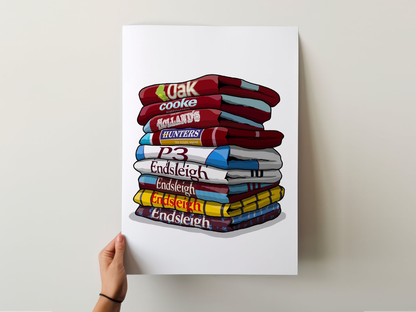 A hand is holding a poster with a stack of colorful towels, each with a different word written on it.