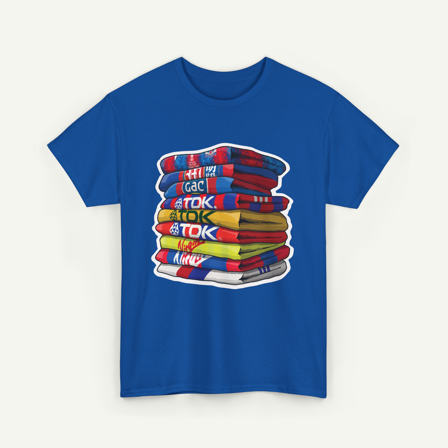 A blue t-shirt with a stack of colorful towels or blankets, each with a different text label.