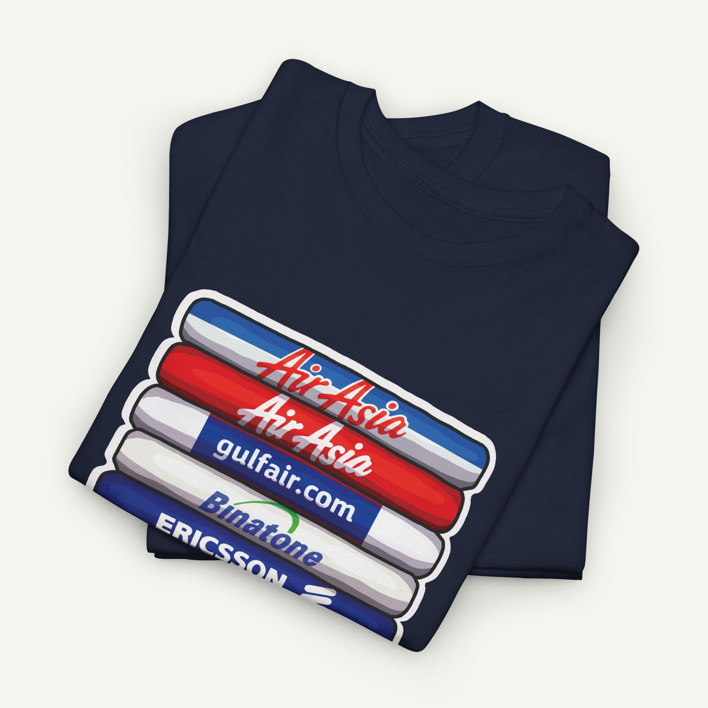 A dark blue t-shirt with a graphic design featuring a stack of three colored markers, each with a different company logo printed on it.