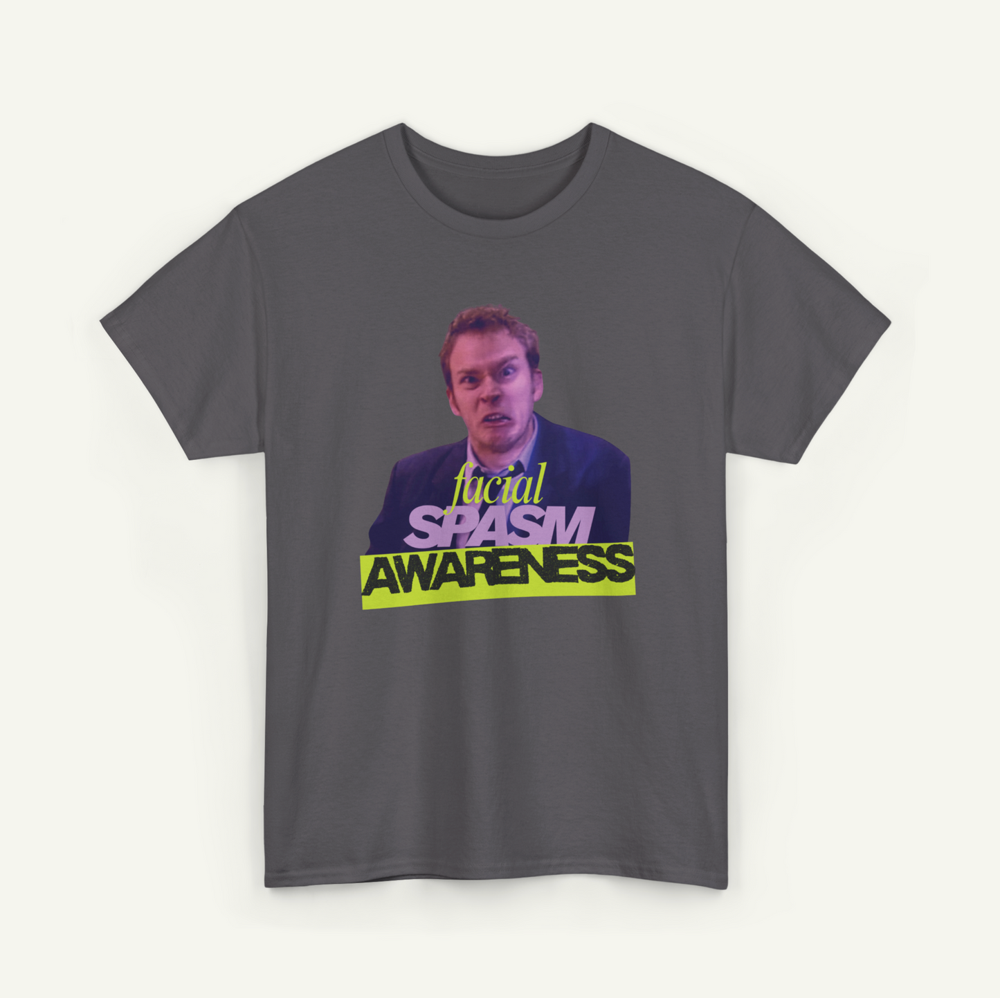 A gray t-shirt with a graphic design featuring a man's face and the text "Local Spasm Awareness" in a stylized font.