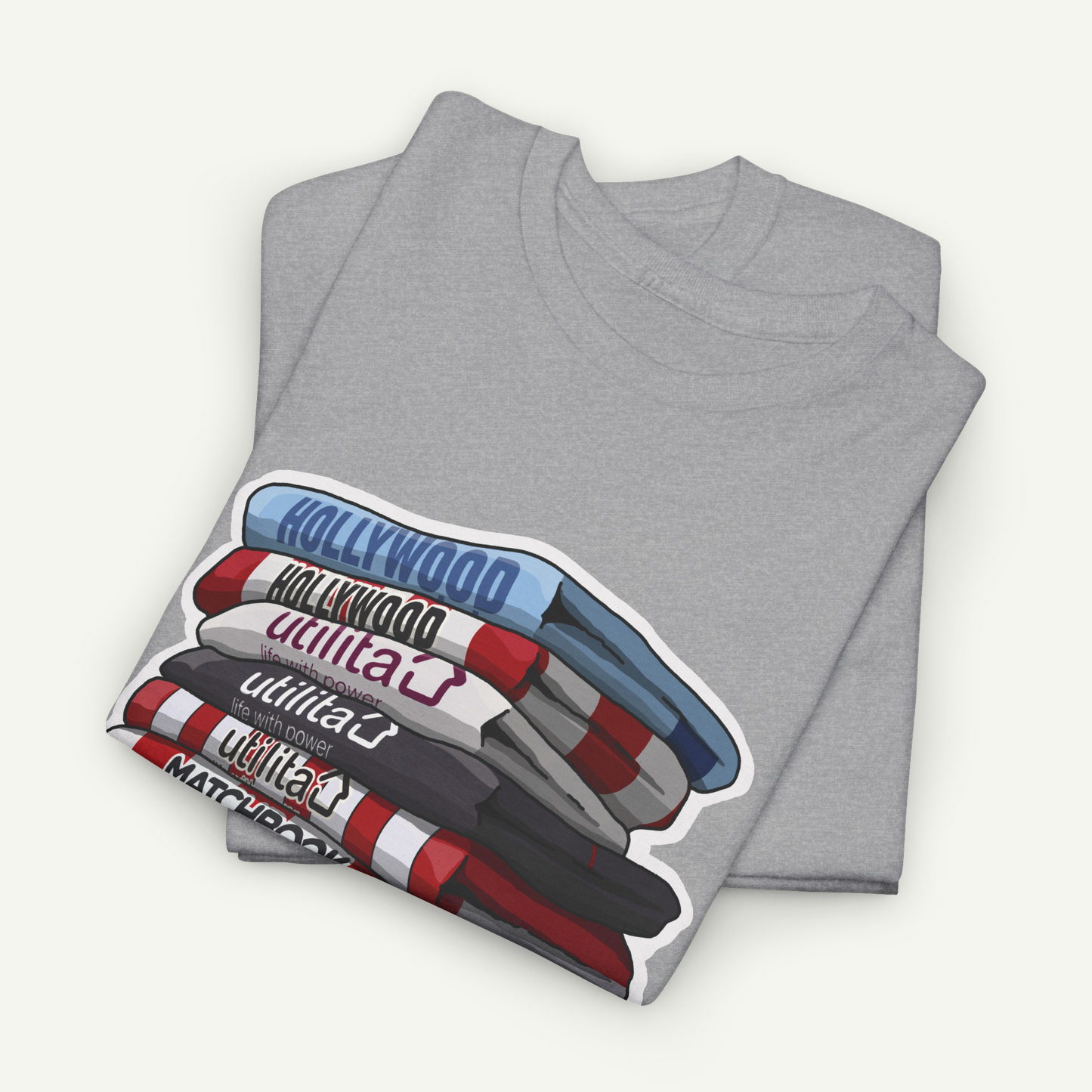 A gray t-shirt with a graphic design depicting a stack of colorful markers or pens, with the word "Hollywood" written on them.
