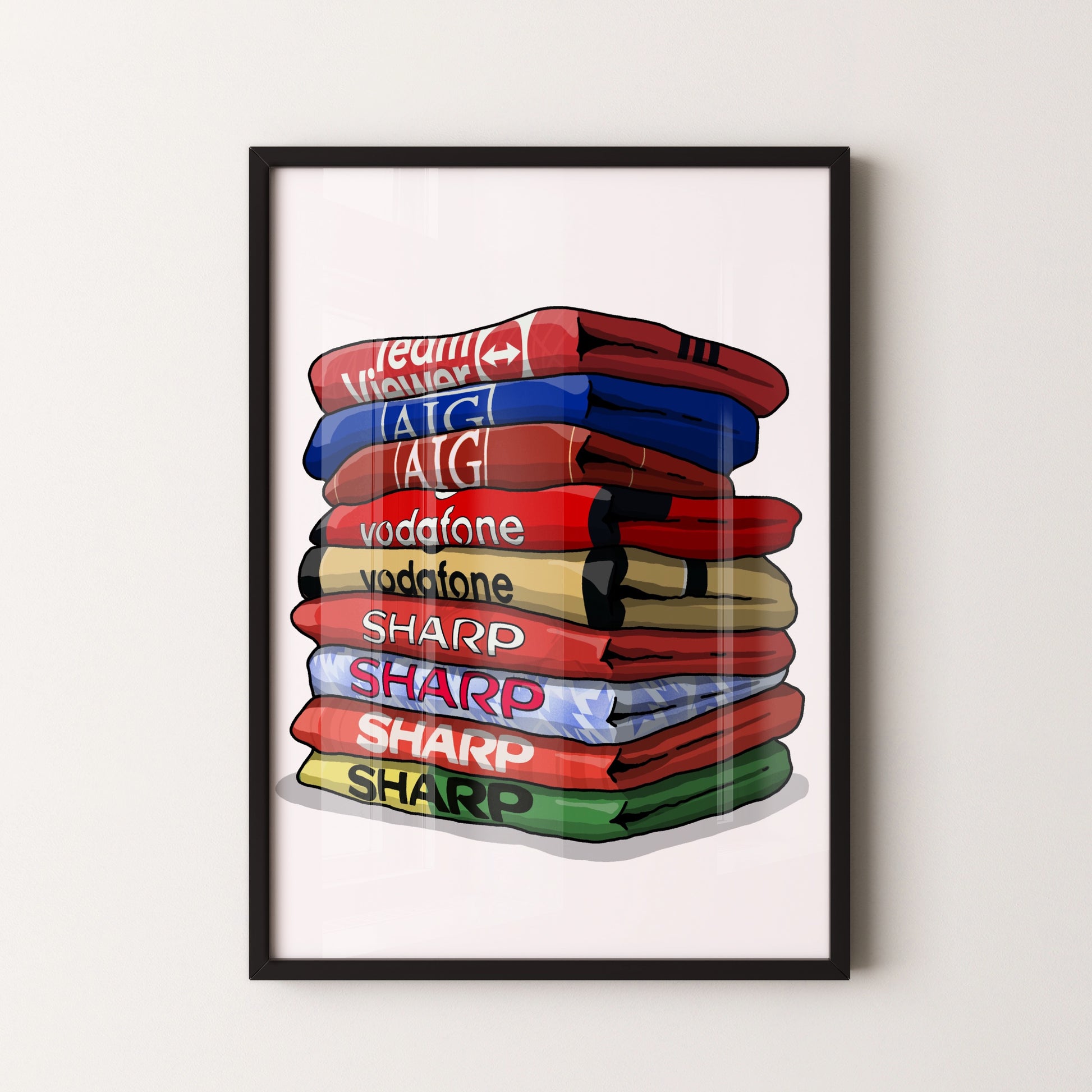 A framed illustration of a stack of colorful towels with various text on them, including "Team Vodafone", "vodafone", "SHARP", "SHARP", and "SHARP".