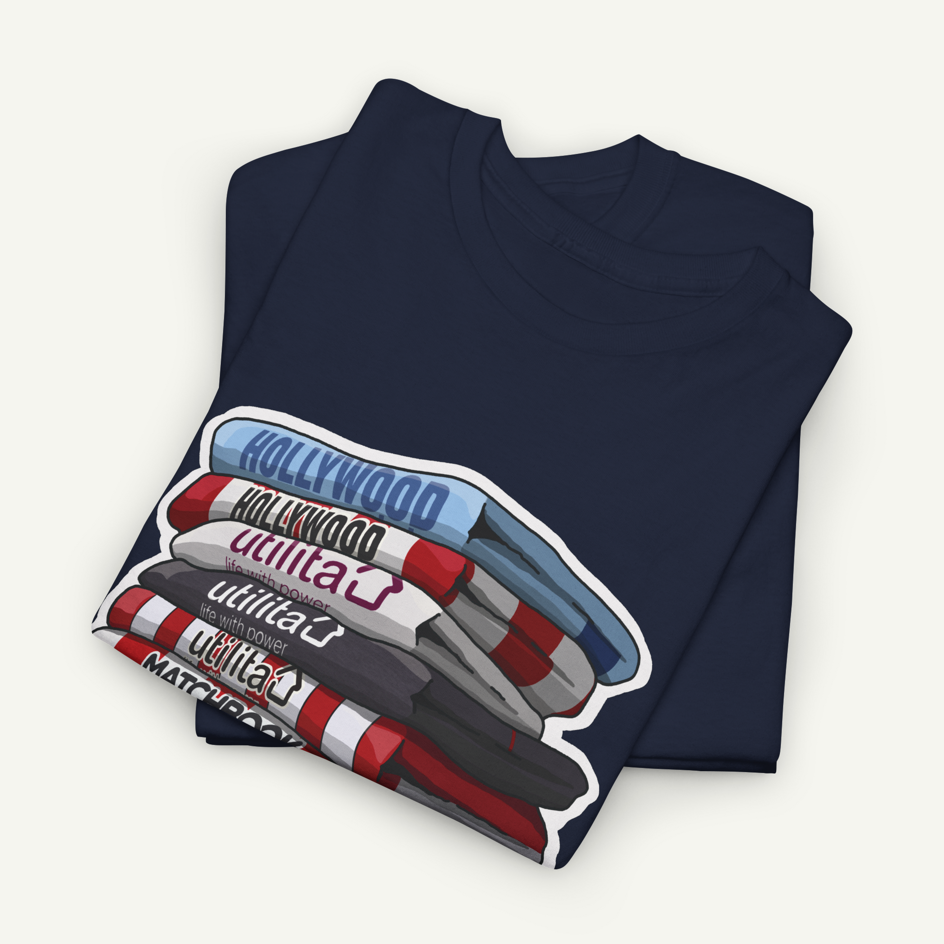 A navy blue t-shirt with a graphic design depicting a stack of colorful markers or pens, with the word "Hollywood" written on them.