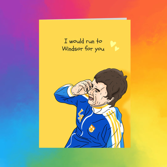 a person wearing a blue and yellow jacket with a yellow heart symbol on the left side of the chest.