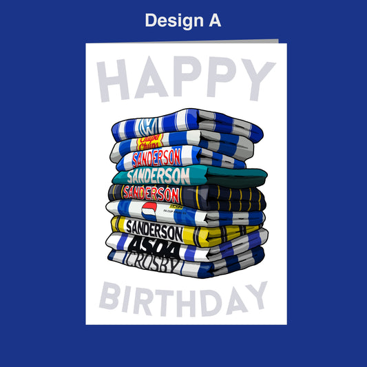 A stack of colorful towels with the text "Happy Birthday" written on them, set against a blue background.