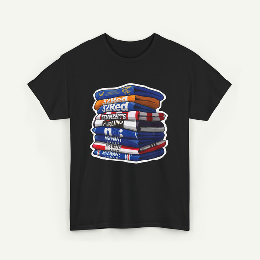 A black t-shirt with a graphic design depicting a stack of colorful towels or blankets.