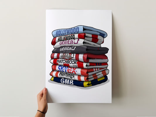 A hand is holding a poster with a stack of colorful towels, each displaying a different brand logo.