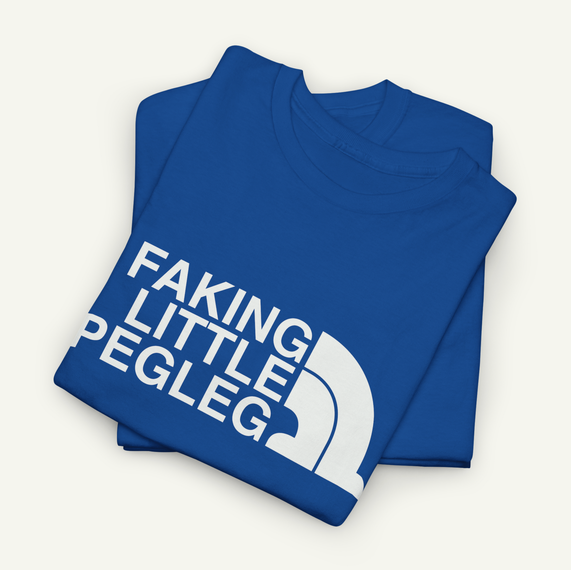 A blue t-shirt with the text "FAKING LITTLE PEGLEG" printed on it.