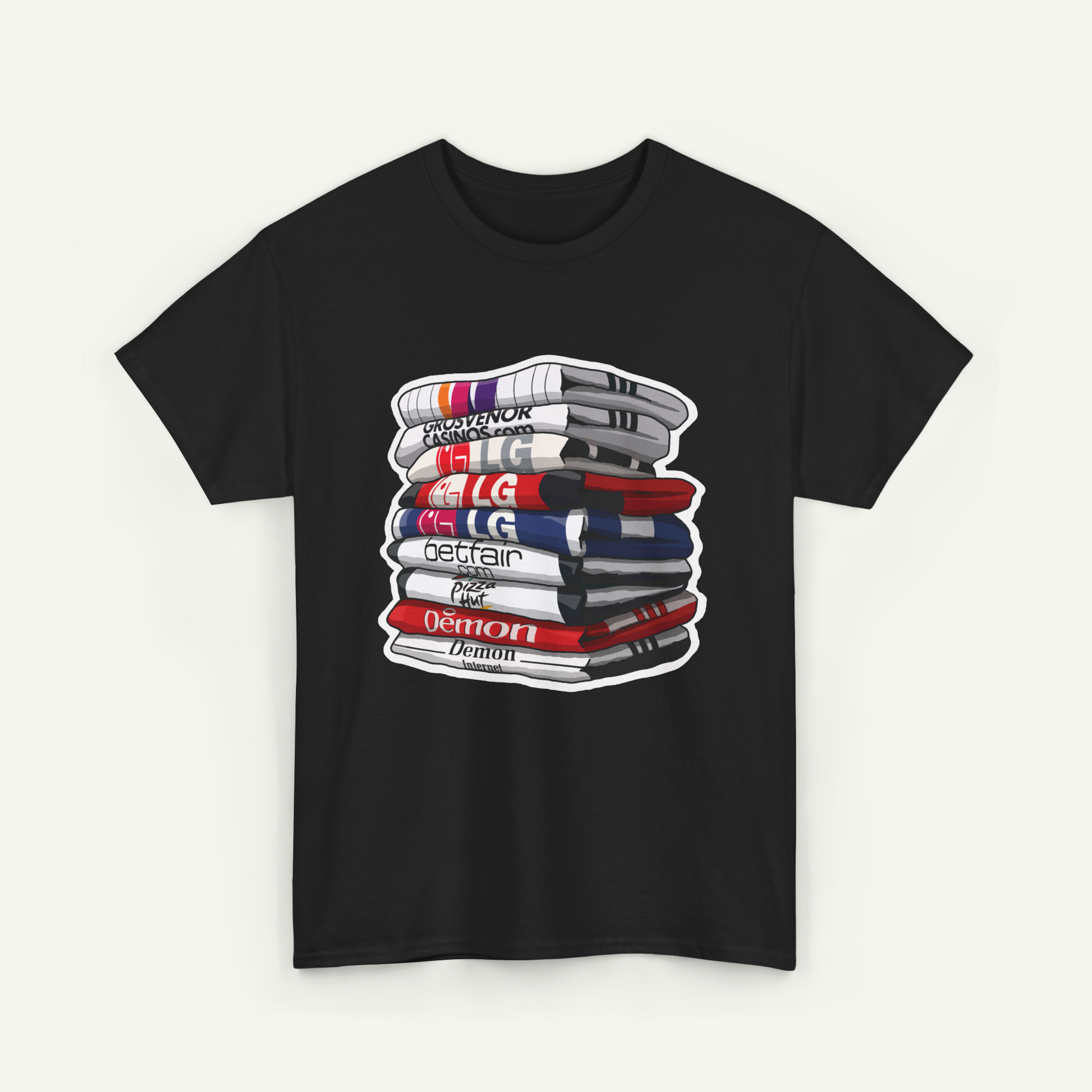 A black t-shirt with a graphic design depicting a stack of books or magazines with various text and logos on the covers.
