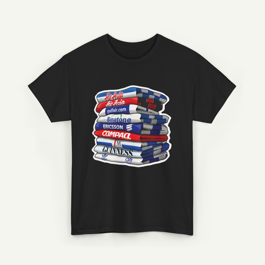 A black t-shirt with a graphic design depicting a stack of books or magazines with various text and logos on them.