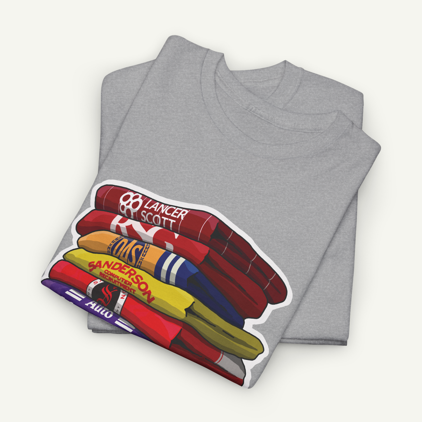 A gray t-shirt with a graphic design depicting a stack of colorful books or magazines.