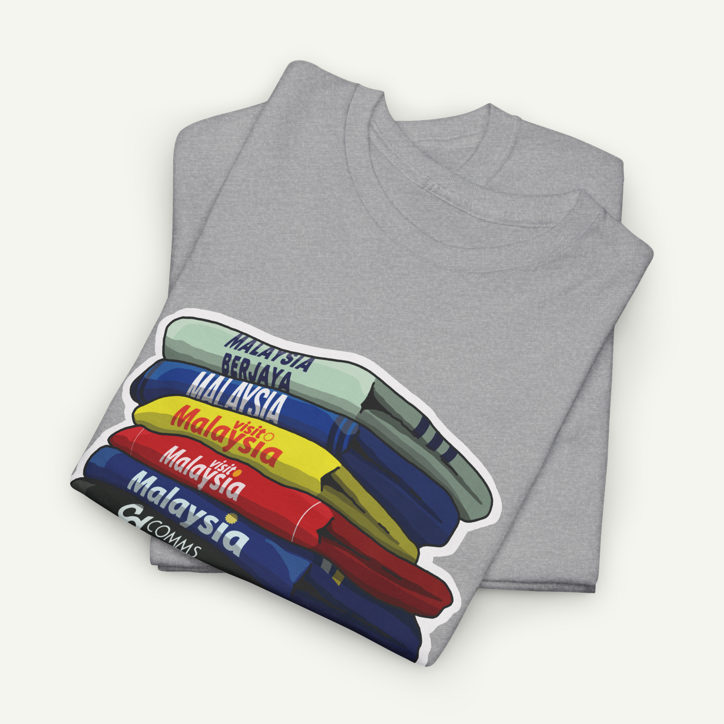 A gray t-shirt with a graphic design depicting a stack of books or books, with the text "Malaysia" written on each book cover.