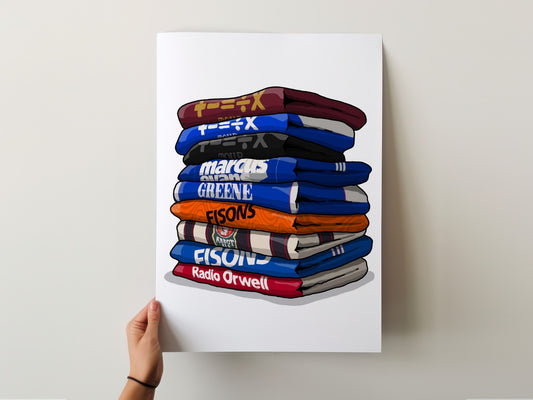 A hand is holding a poster with a stack of colorful towels, each with a different text logo on it.