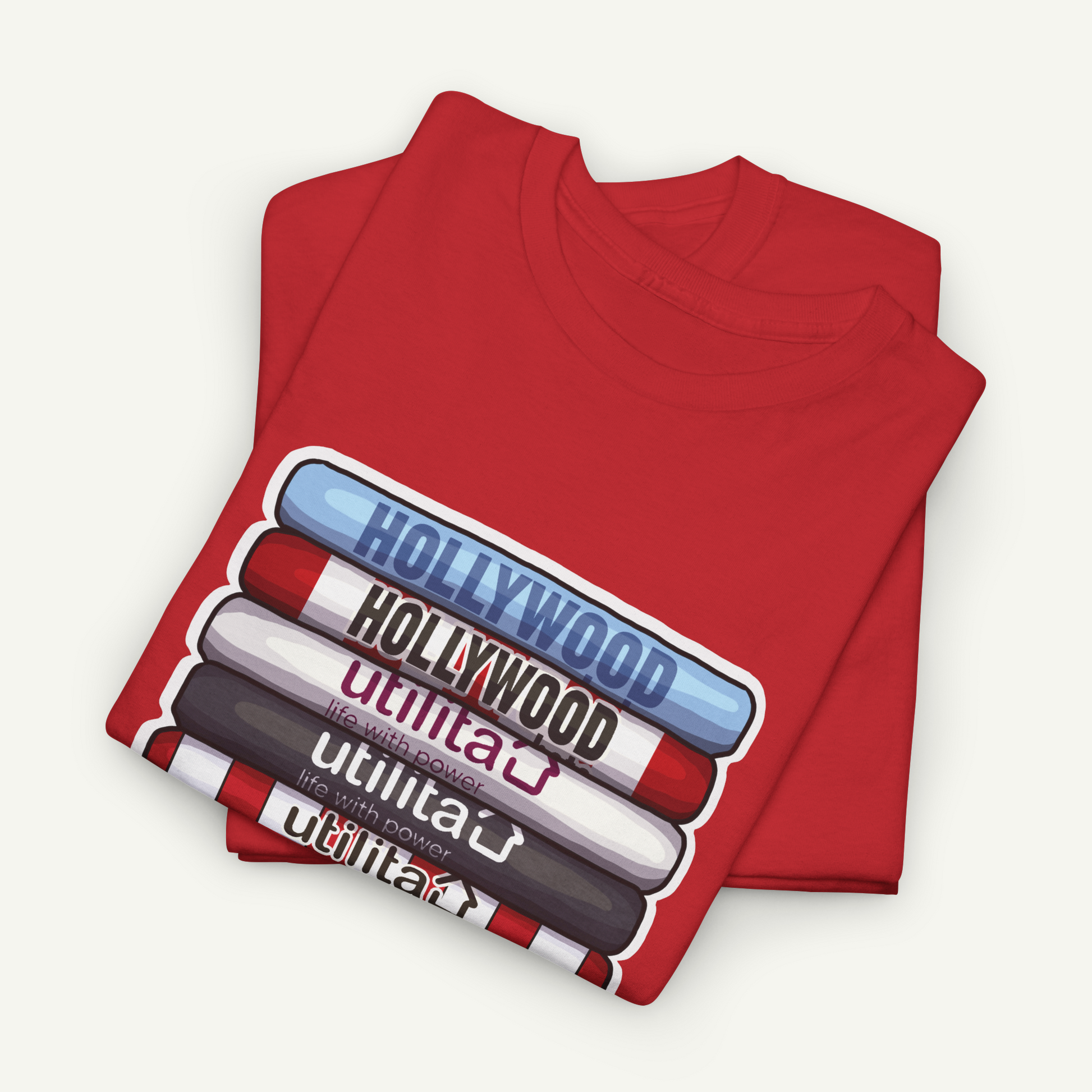 A red t-shirt with a graphic design depicting the words "Hollywood" in various colors, including red, blue, and white, arranged in a stacked formation.