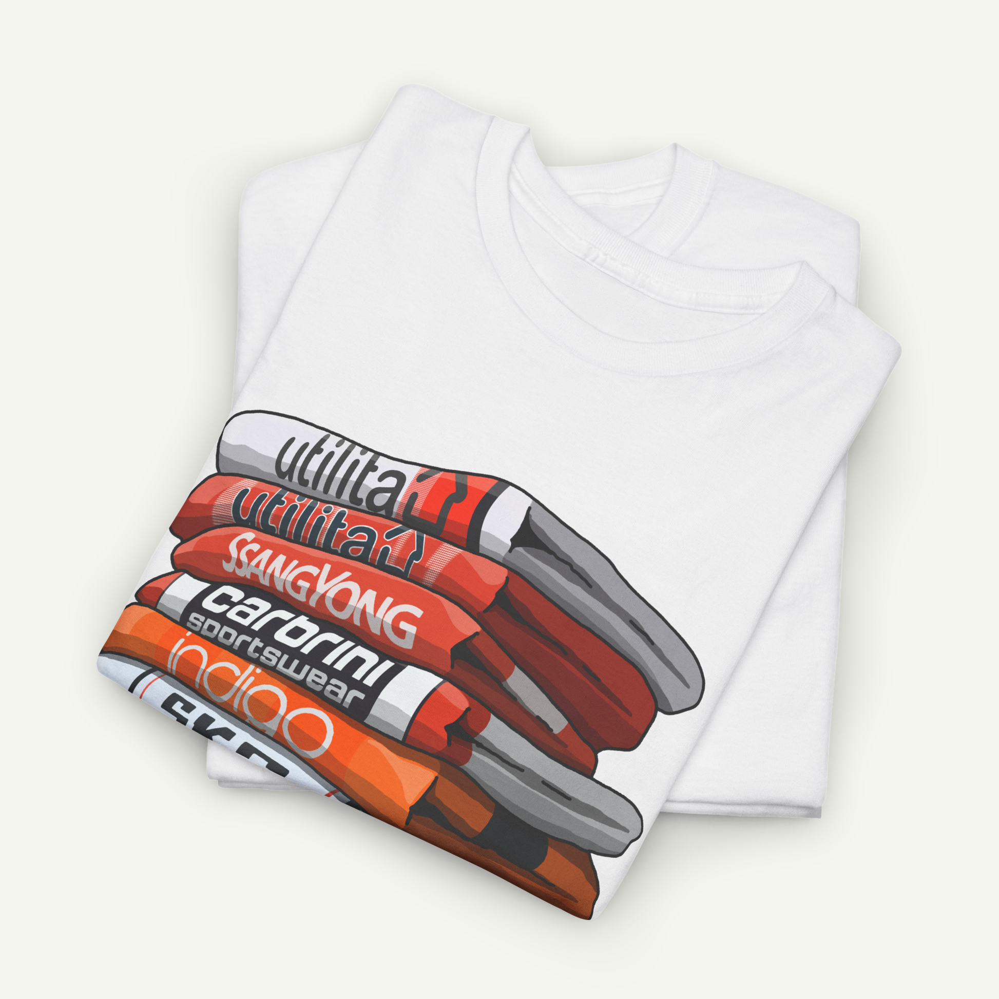 A white t-shirt with a graphic design depicting a stack of various colored objects, including orange, red, and white.
