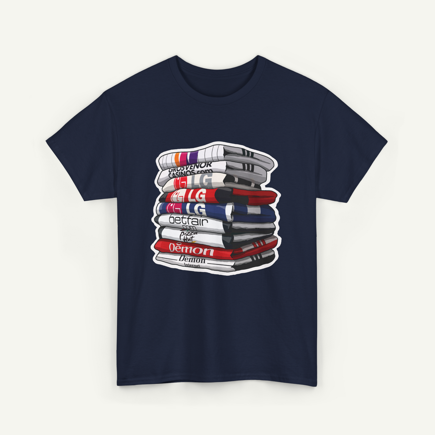 A navy blue t-shirt with a graphic design depicting a stack of books or magazines with various text and logos on the covers.