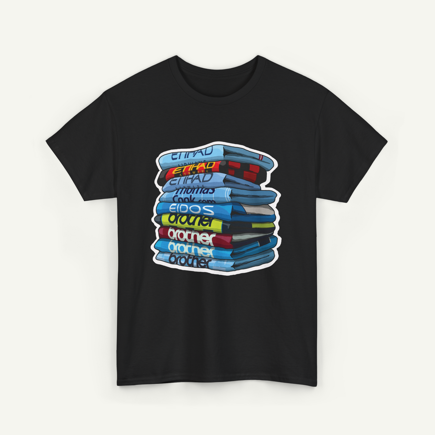 A black t-shirt with a graphic design depicting a stack of colorful books or magazines.