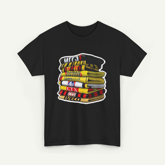 A black t-shirt with a graphic design depicting a stack of books or magazines with various text and logos on the covers.