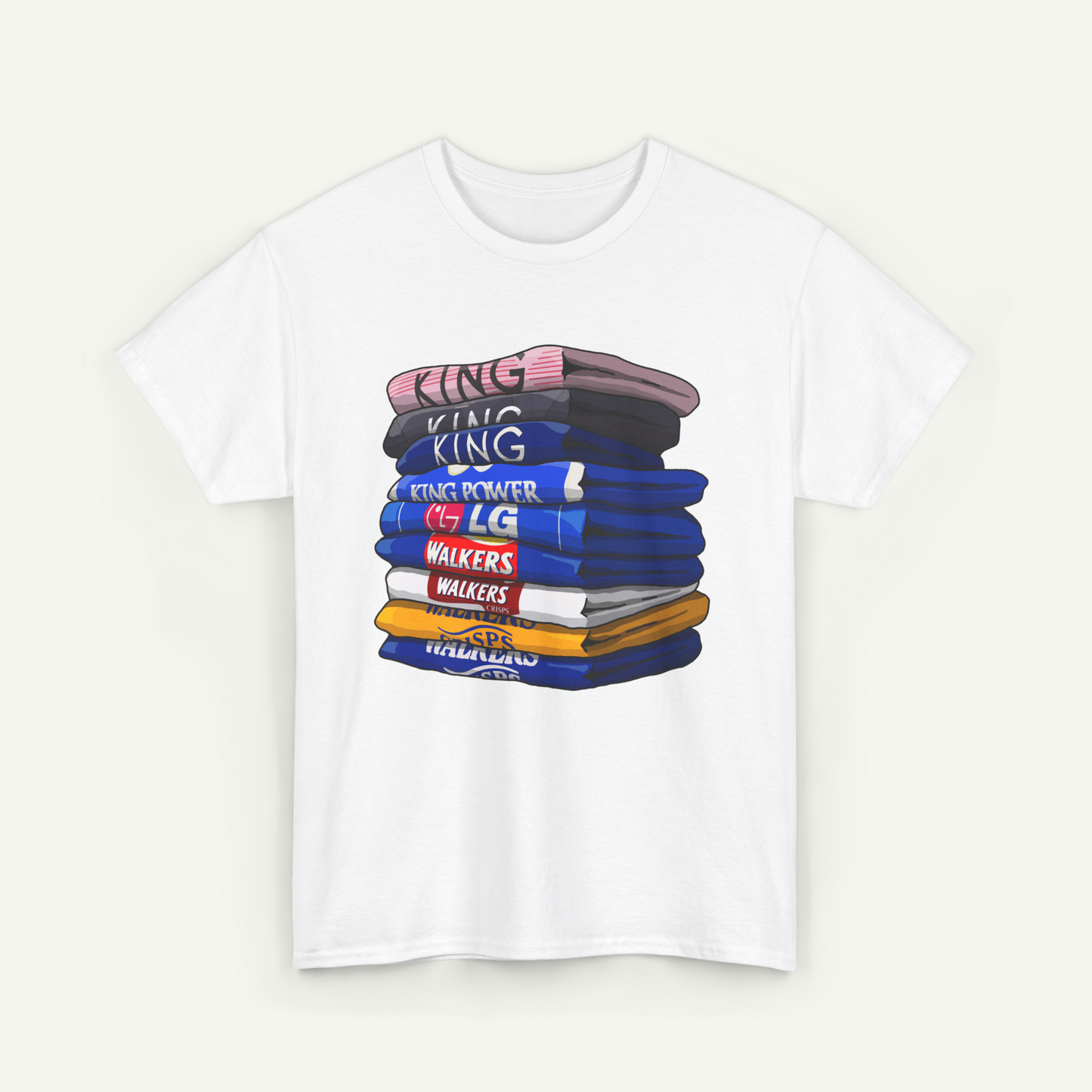 A white t-shirt with a graphic design depicting a stack of colorful books or books with various text on them.