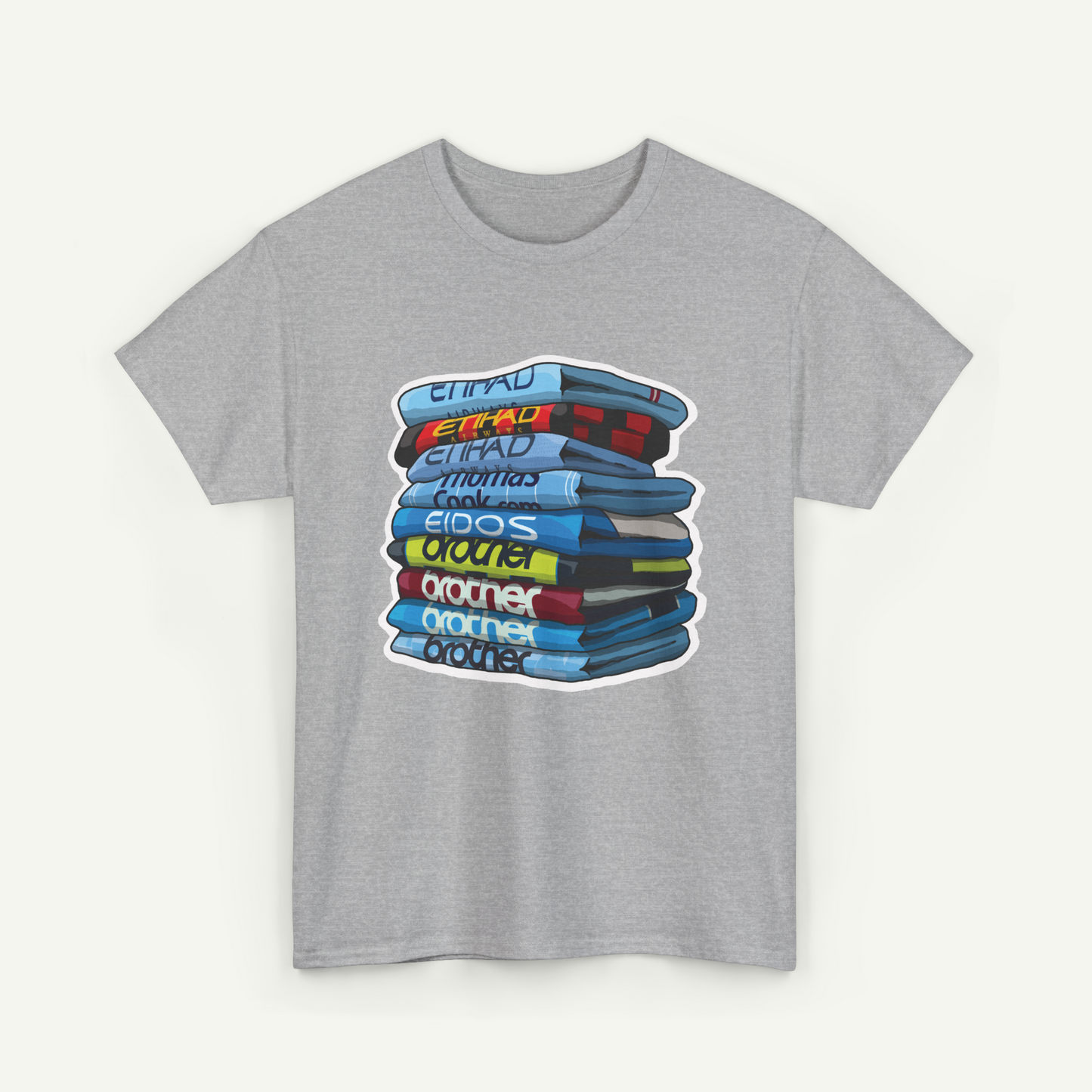 A gray t-shirt with a graphic design depicting a stack of colorful books or magazines.