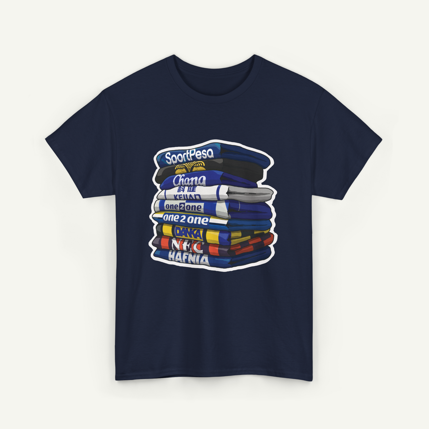 A navy blue t-shirt with a graphic design depicting a stack of colorful books or magazines with the text "SoortPesa" and "Chama Kei One" printed on them.