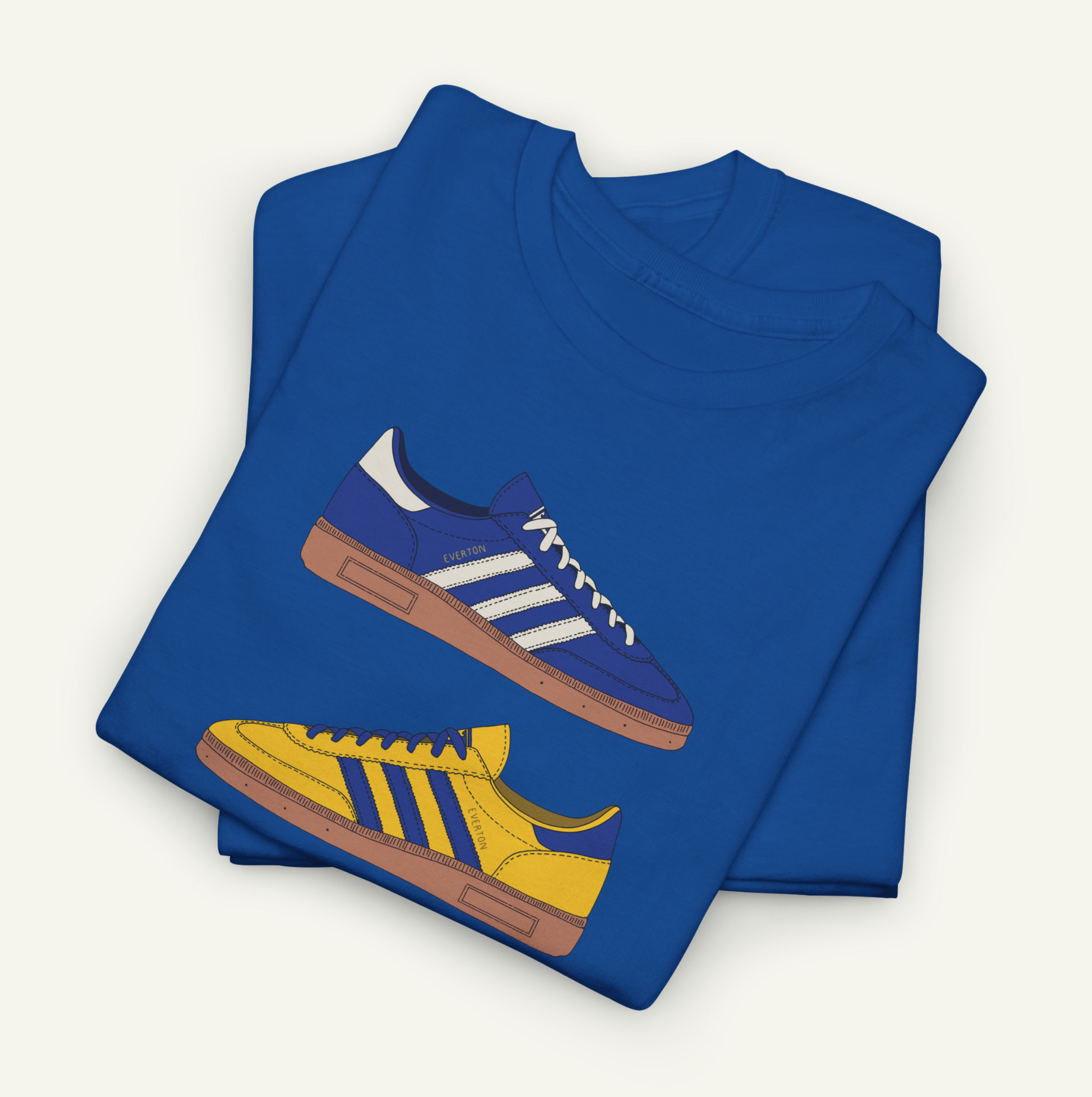 A blue t-shirt with a graphic design of two Adidas sneakers, one blue and one yellow, printed on it.