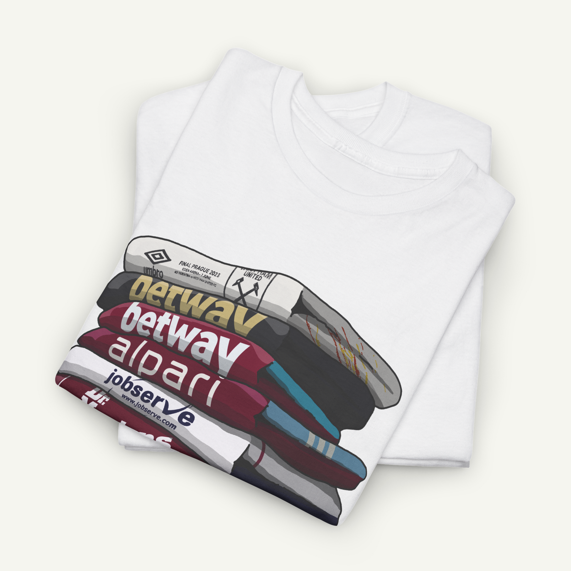 A white t-shirt with a graphic design depicting a stack of books or magazines with various text and logos printed on them.
