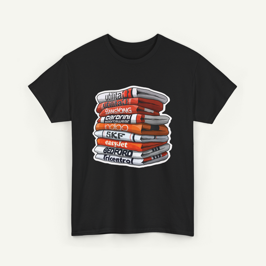 A black t-shirt with a graphic design depicting a stack of books or magazines with various titles and text.