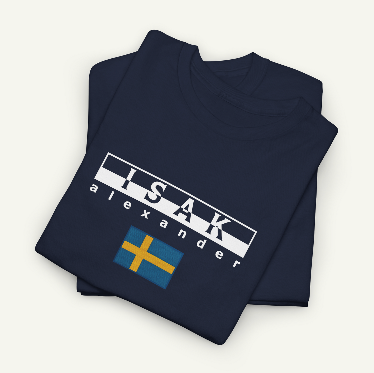 A navy blue t-shirt with the text "ISAK Alexander" printed on it, along with a small flag design.