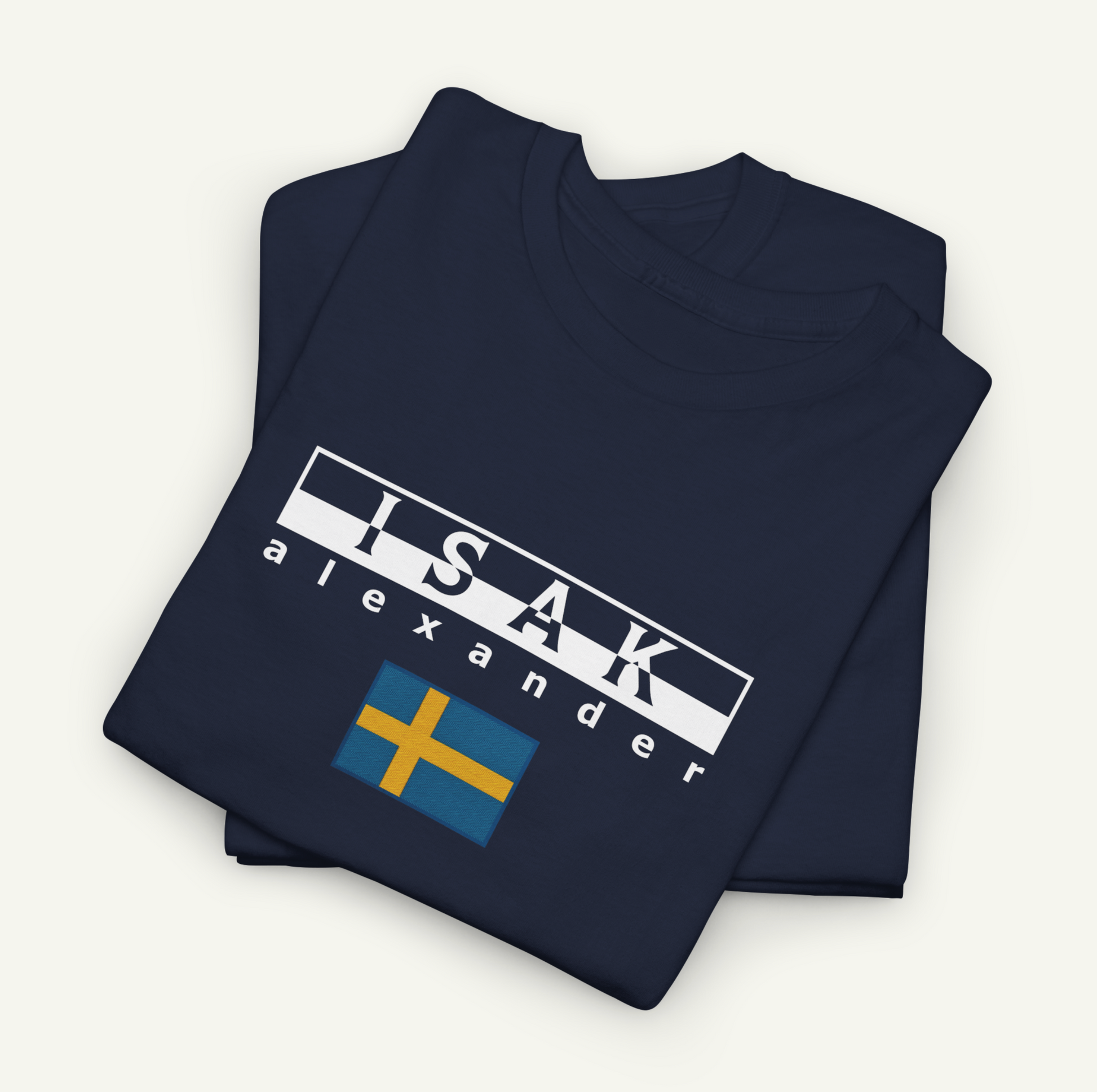 A navy blue t-shirt with the text "ISAK Alexander" printed on it, along with a small flag design.