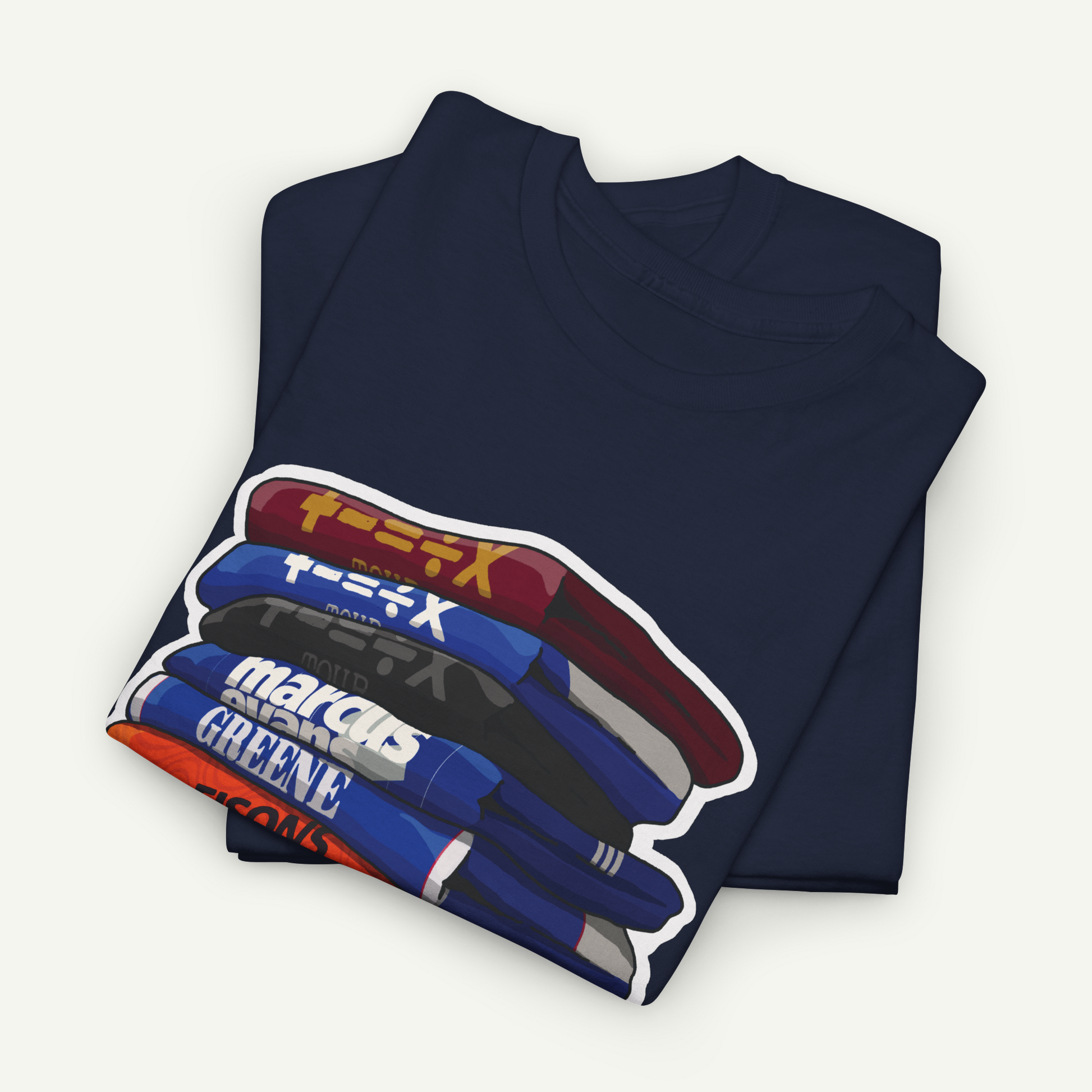 A navy blue t-shirt with a graphic design depicting a stack of books or magazines with various colored covers.