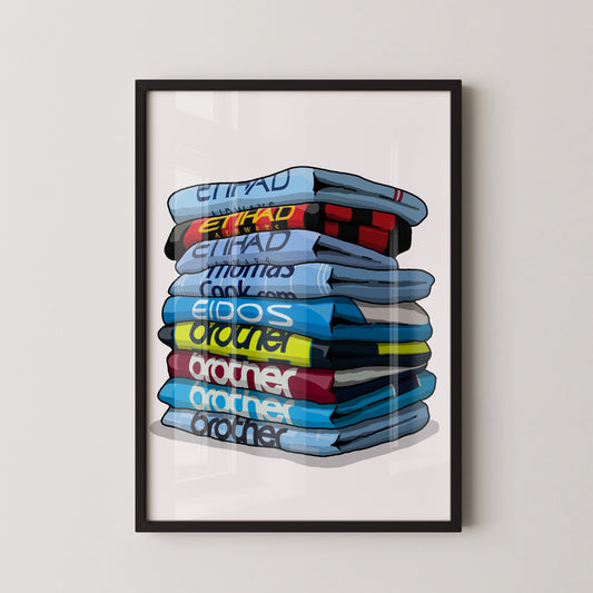 A framed illustration of a stack of various colored shirts, with the text "EIHAD" visible on the shirts.