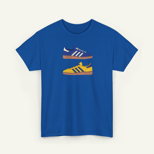 A blue t-shirt with a graphic design of two Adidas sneakers in different colors - blue and yellow.