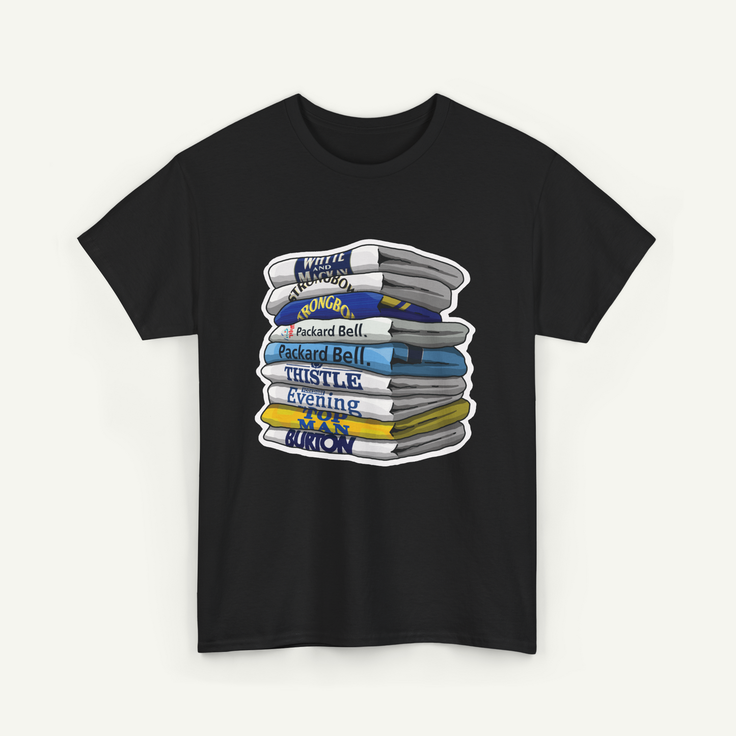 A black t-shirt with a graphic design depicting a stack of books or magazines with various titles and colors.