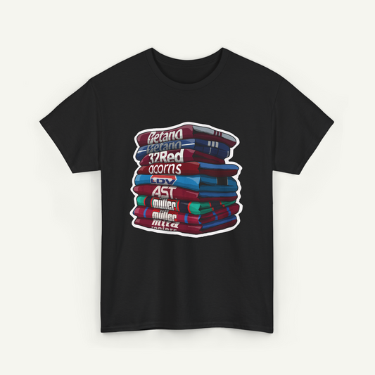 A black t-shirt with a graphic design depicting a stack of colorful books.
