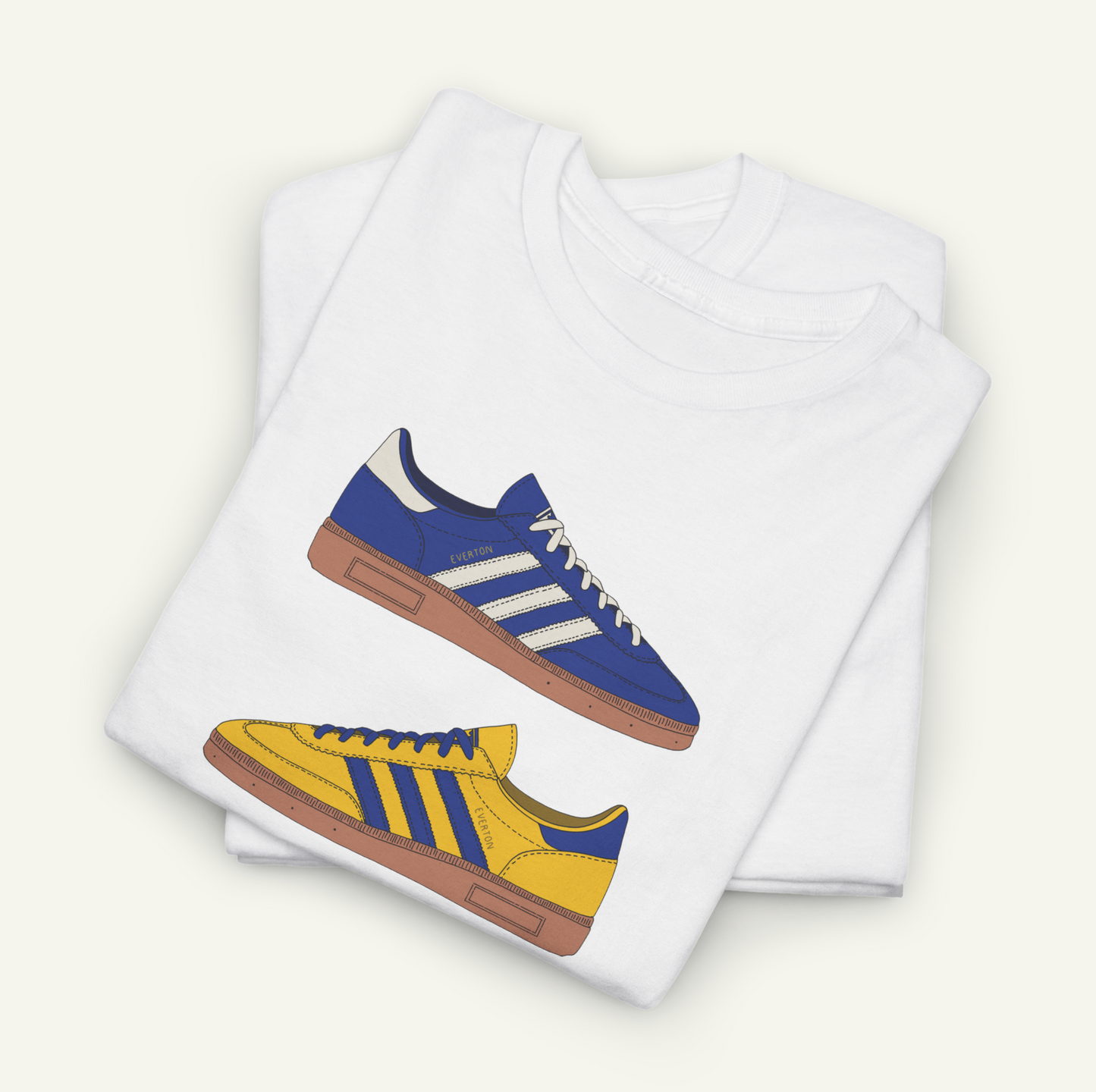 A white t-shirt with a graphic design of two Adidas sneakers, one blue and one yellow, printed on it.