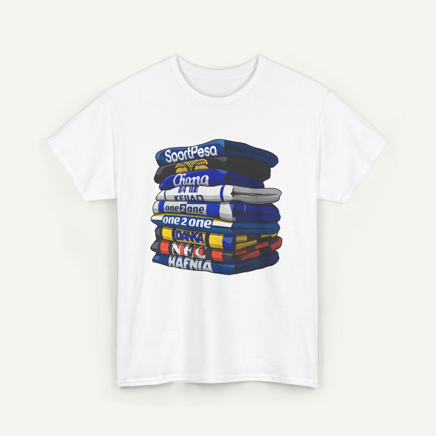 A white t-shirt with a graphic design depicting a stack of colorful books or magazines with various titles and text.