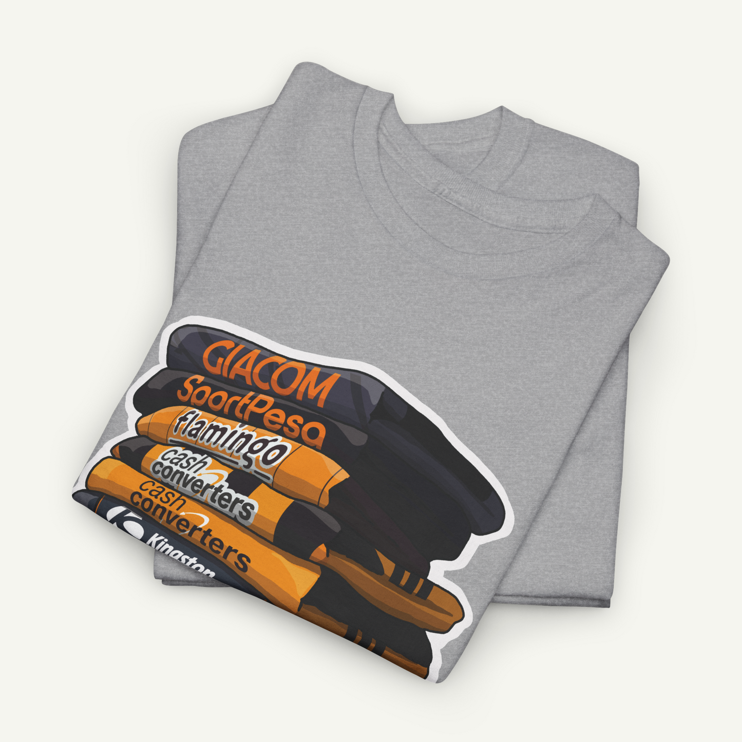 A gray t-shirt with a graphic design depicting a stack of books or magazines with the text "Giacom SoardPesa Flamingo Cash Converters" printed on it.