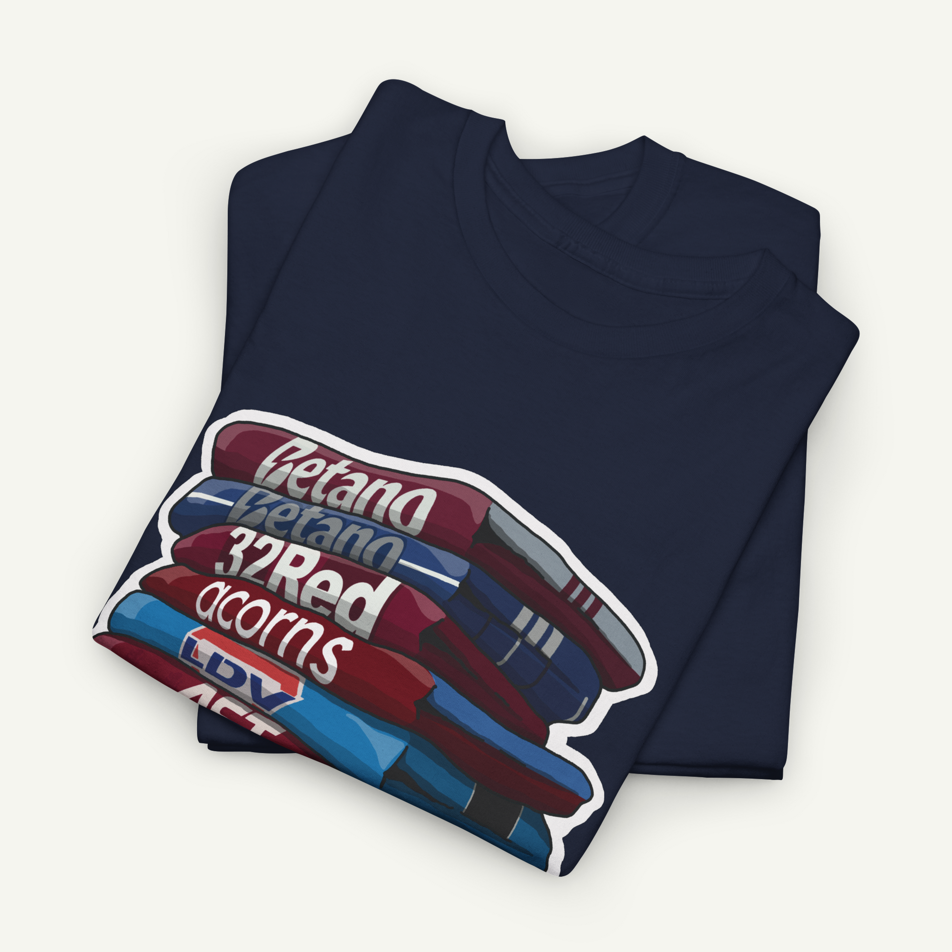 A navy blue t-shirt with a graphic design depicting a stack of colorful books or magazines.