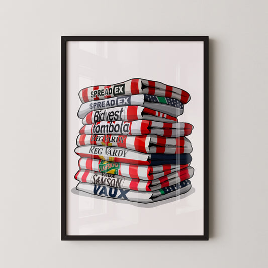 A framed illustration of a stack of towels with various text printed on them, including "SPREADEX", "Budapest", "Tombola", "Reg Army", "Reg Vardy", "Lamborghini", and "Samson Vaux".
