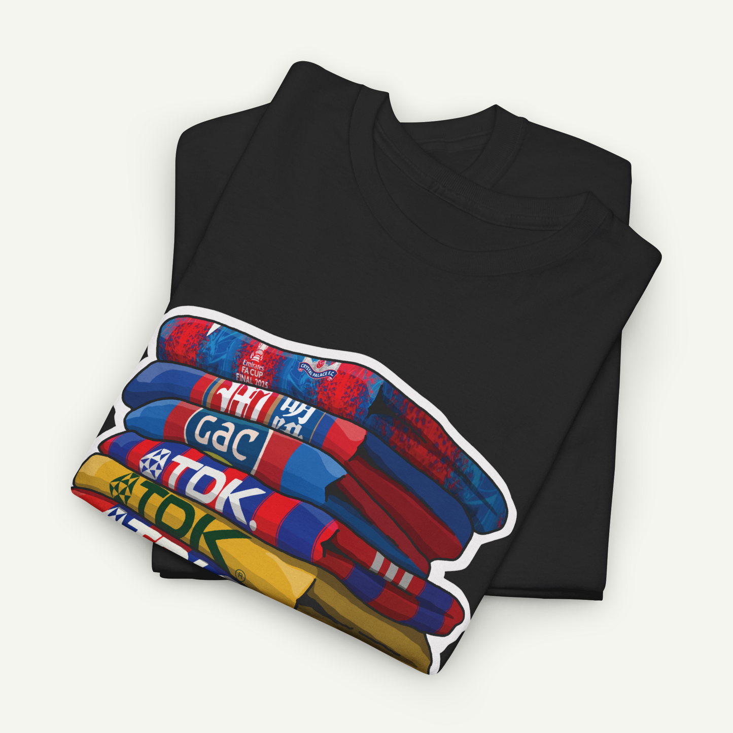 A black t-shirt with a colorful graphic design on the front, depicting a stack of books or other objects.