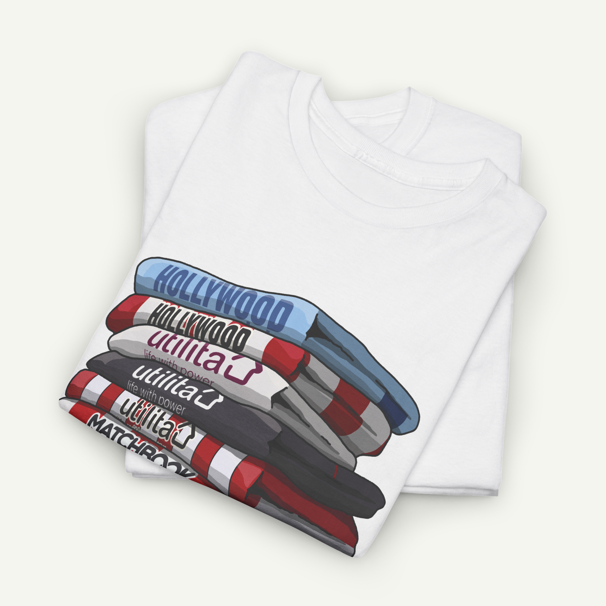 A white t-shirt with a graphic design depicting a stack of books or magazines with the text "Hollywood" printed on them.