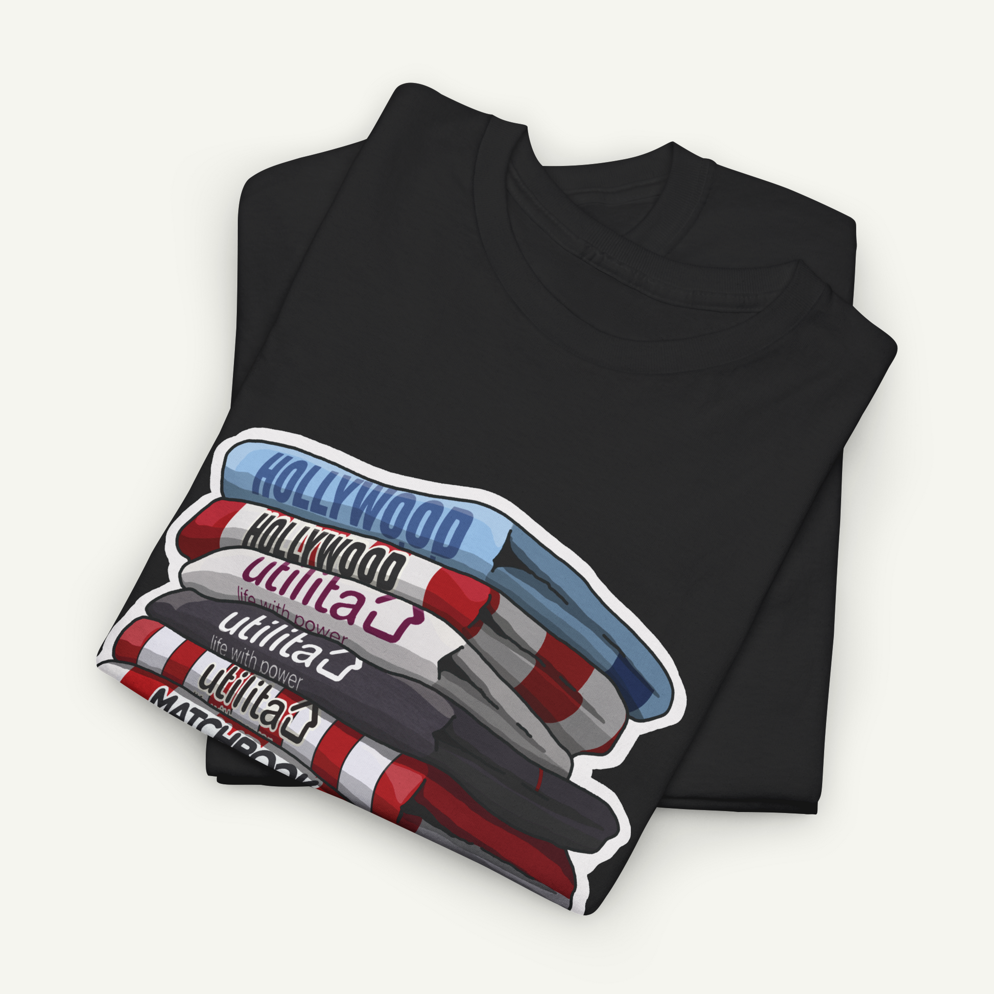 A black t-shirt with a graphic design depicting a stack of colorful markers or pens, with the word "Hollywood" written on them.