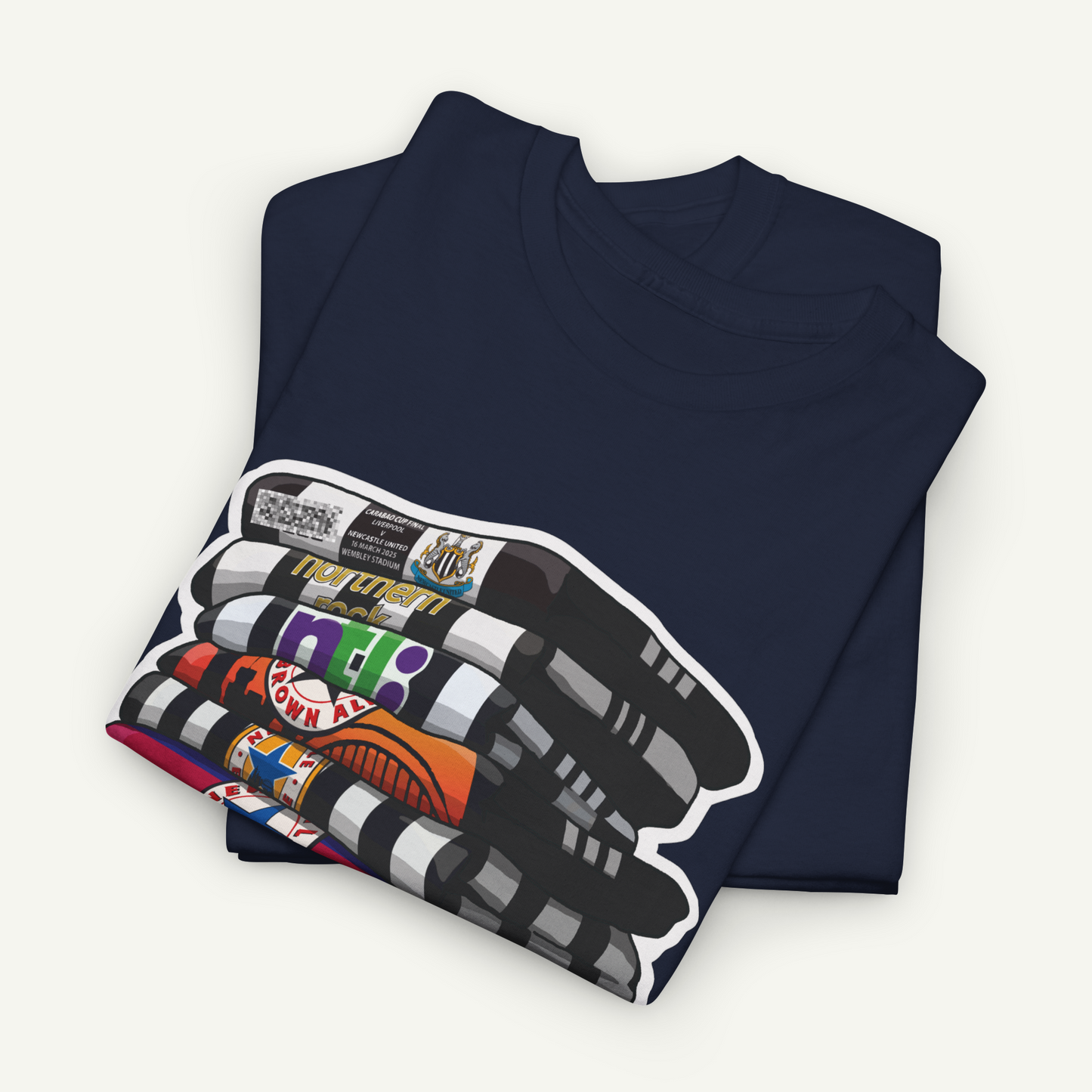A navy blue t-shirt with a colorful graphic design on the front, featuring a stack of crayons and various other objects.
